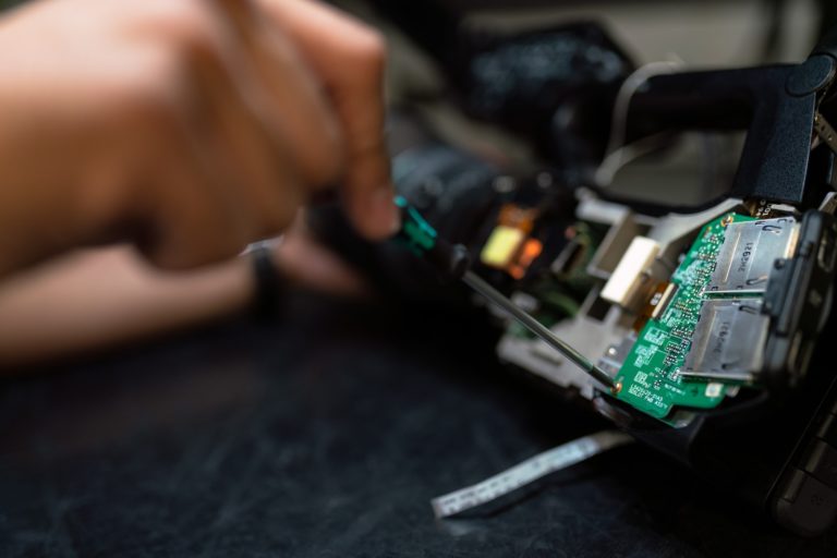 person holding green and black circuit board 768x512