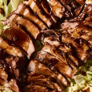 a close up of meat and lettuce on a plate