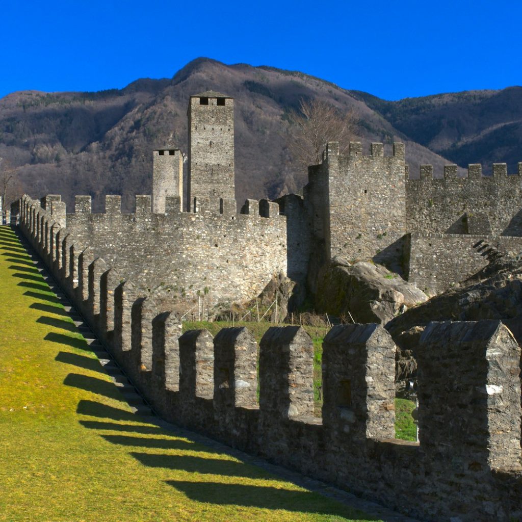 a large stone castle with a mountain in the background