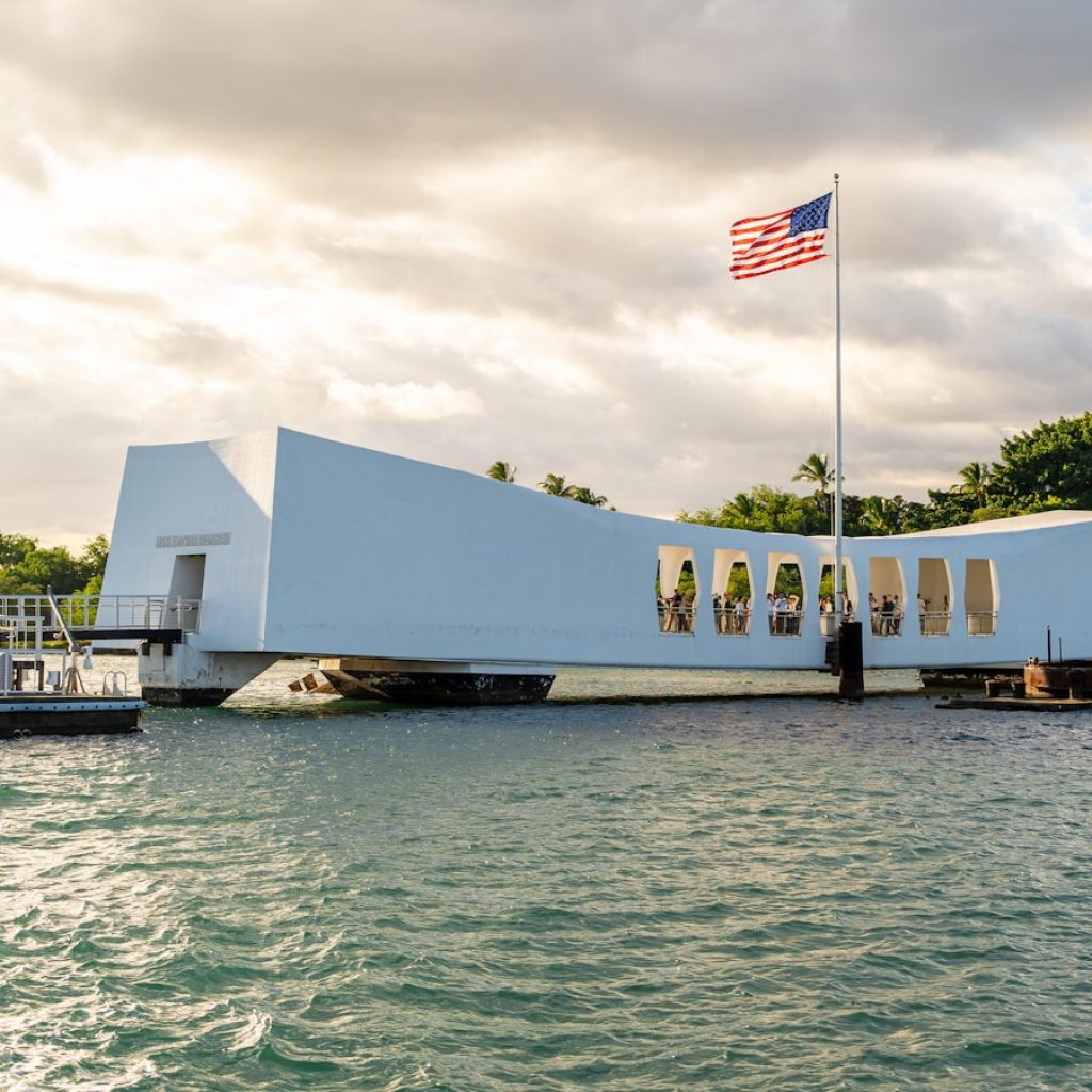 A large white building sitting on top of a body of water